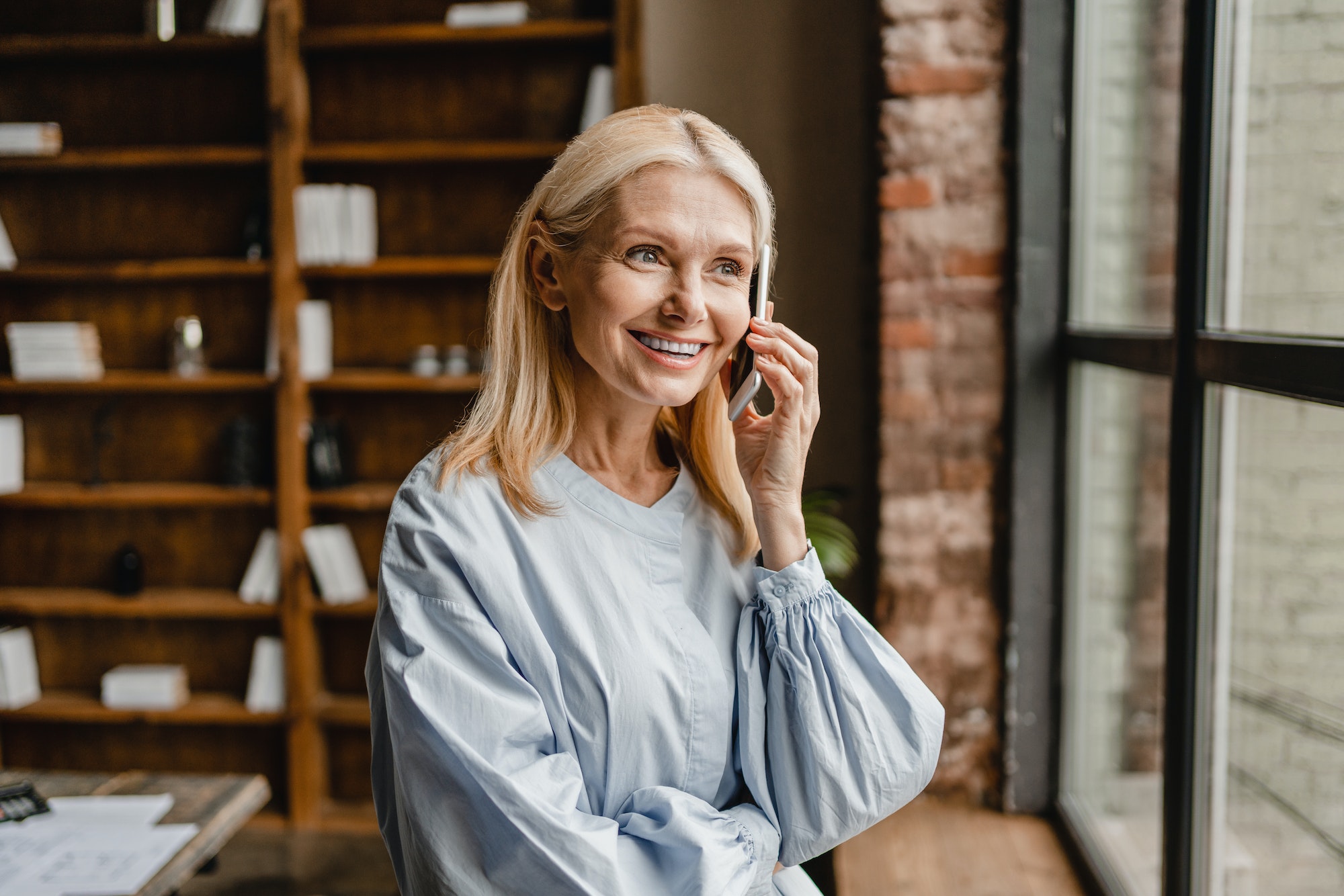 Woman talking on smart phone cellphone with business partners colleagues relatives food delivery